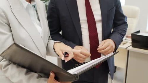 Business People Discussing Documents in Modern Office