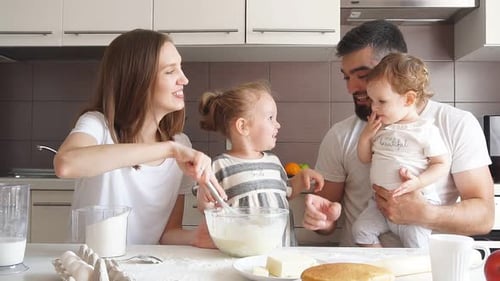 Young Parents and Their Kids Learning the Secrets of Cooking