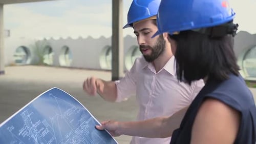 Architects Review Blueprints at Urban Construction Site