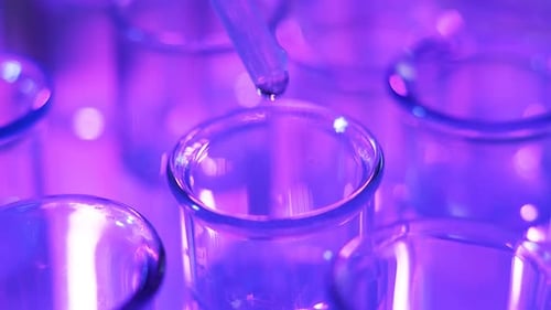 Clear Fluid Dripping into Test Tube in Lab