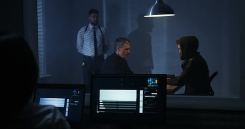 Tense Interrogation Underway in Dark Room