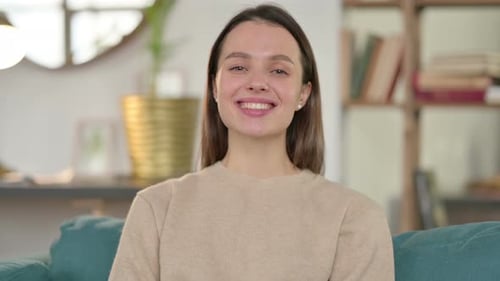 Smiling Woman on Couch Looking at Camera