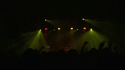 Energetic Concert Lights with Silhouetted Crowd