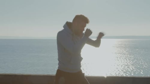 Young Adult Training Boxing Near Water