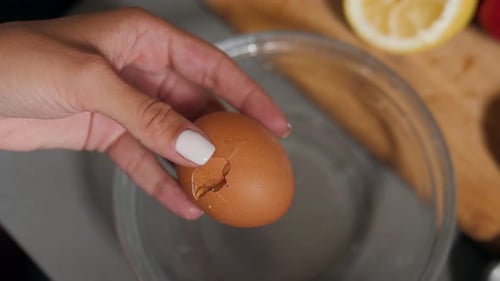 Breaking an Egg into a Glass Bowl