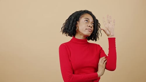 Woman Gesticulating and Talking Against a Neutral Background
