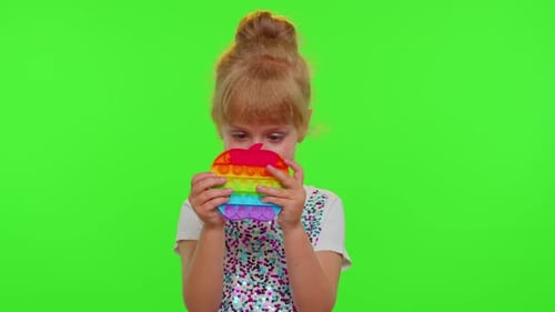 Stylish Child Girl Playing Colorful Squishy Silicone Bubbles Sensory Pop It Toy Game on Chroma Key