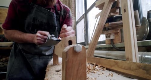 The Master Carpenter with a Planer at Work in the Workshop