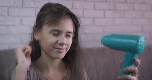 Child Brushing Hair with a Toy Hair Dryer