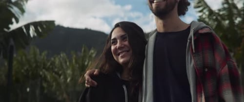 Happy Couple Walking on Tropical Path Together