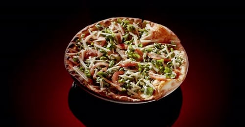 Delicious Pizza with Green Toppings on Plate