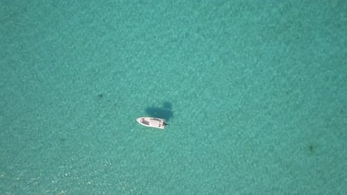 Aerial drone view of a fishing motor boat in the Bahamas, Caribbean.