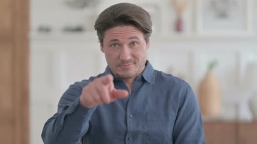 Portrait of Young Man Pointing at the Camera and Inviting
