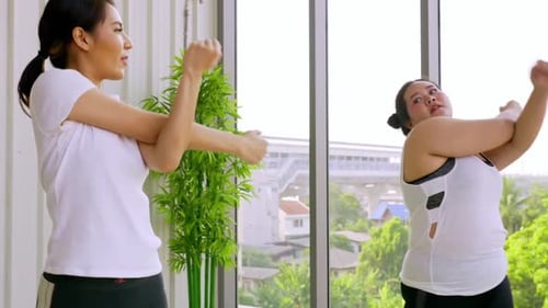 Women Stretching Arms During a Fitness Workout