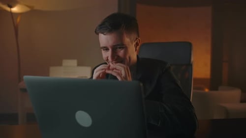 Young Adult Working Hard on Laptop at Night