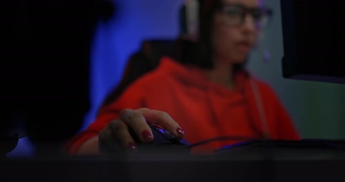 Woman Gaming with Headset in Dimly Lit Room