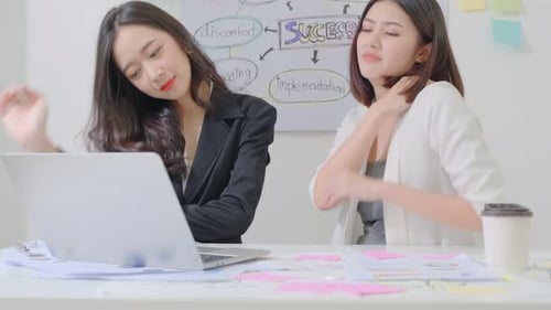 Two Women Working Together in an Office
