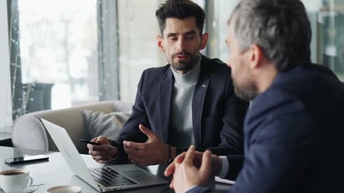 Entrepreneurs Men Communicating in Cafe Discussing Possible Partnership