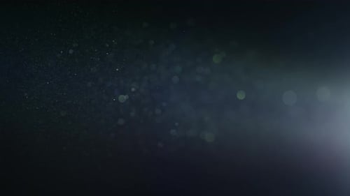 Glowing Particles and Bokeh on Dark Background