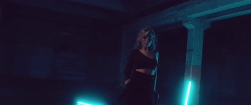 Female Dancer in a dark Parking Lot with Neon Lights