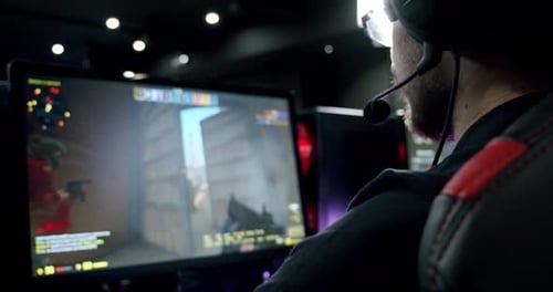 the Gamer Plays an Online Video Game, and Comments Into the Microphone , Close Up