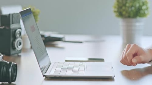 Laptop Typing with Vintage and Modern Camera