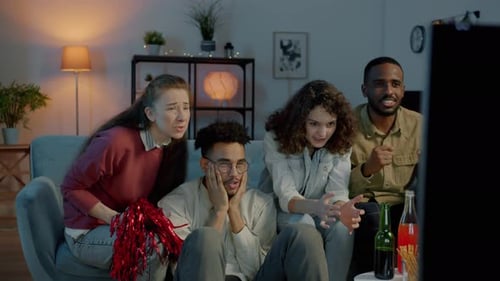 Excited Friends Watching Sports at Home at Night
