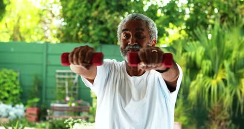 Senior Man Exercising with Dumbbells Outdoors
