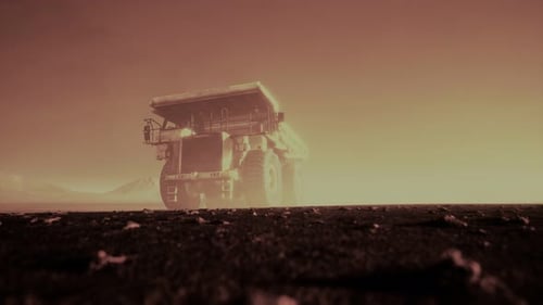 Giant Mining Dump Truck Driving Through Dusty Industrial Site