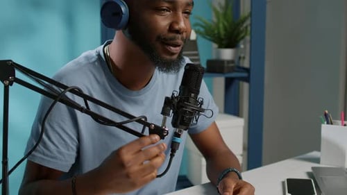Close Up of Vlogger Using Microphone and Headphones