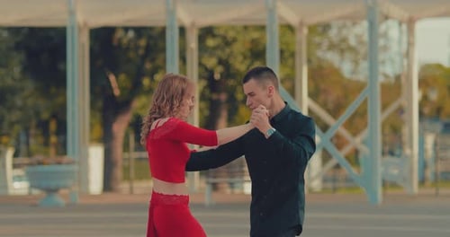 Pair of Beautiful Young People Dancing Tango on the Street