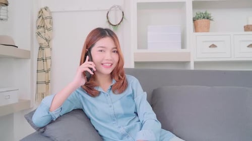 Smiling Woman Chatting on Phone Indoors