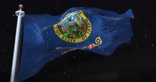 Realistic Waving Idaho State Flag with Rain at Night