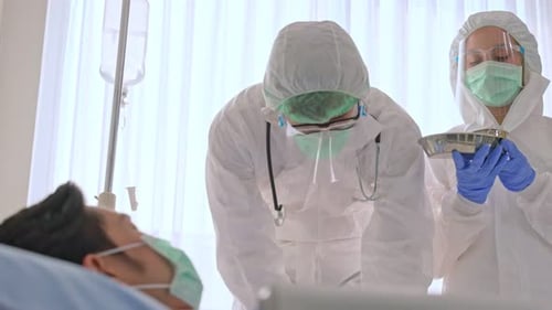 Healthcare Workers Preparing Injection for Patient in Hospital