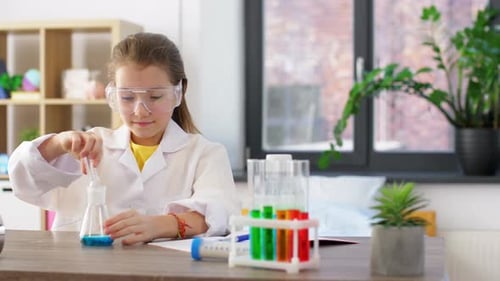 Girl Doing Chemistry Experiment at Home in Lab Coat