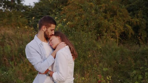 Closeup of a Beautiful Girl and Boy Hugging in a Park