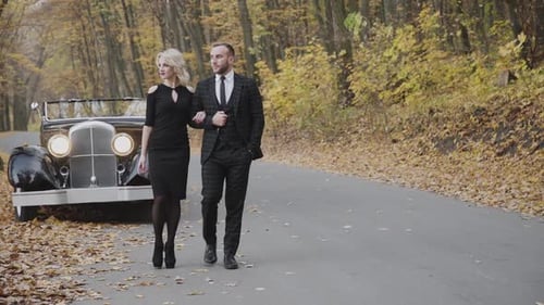 Romantic Couple Walking Under the Arms Foot to Foot in Park at Cabriolet