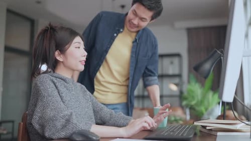 Couple Embracing in Home Office