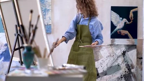 Woman Painting in Studio Art Workspace