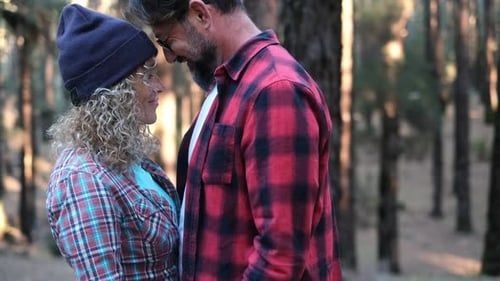 Adult couple hug and kiss with love in the nature outdoor leisure activity at the park - romance