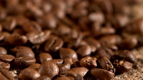 Coffee Beans on Burlap Sacking Background, Rotation, Close Up