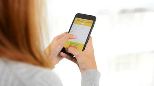 Woman checking hotel information online before booking in smartphone application