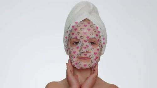 Child with Heart Face Mask Touches Skin