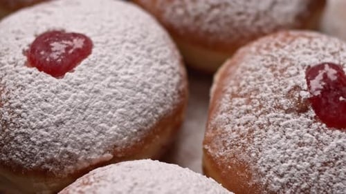 Powdered Sugar Donuts Topped with Red Jam