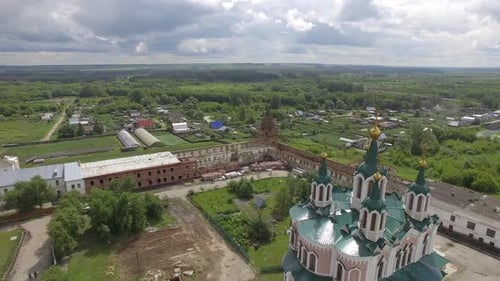 Aerial view of beautiful church in monastery surrounded by a brick wall