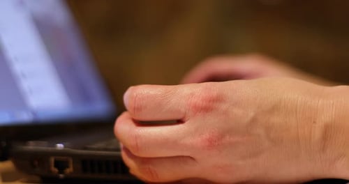 Hands Typing on a Black Laptop Keyboard