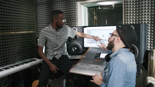 Singer and Sound Engineer Discussing New Track