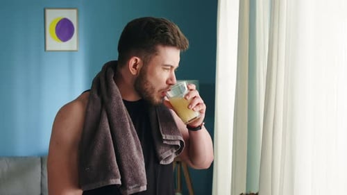 Strong Man Drinks Multivitamin Beverage