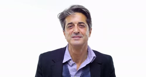 Gray-haired Man Looks Upward Against White Background