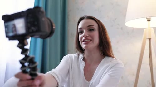 Young Woman Records Video Blog with Camera